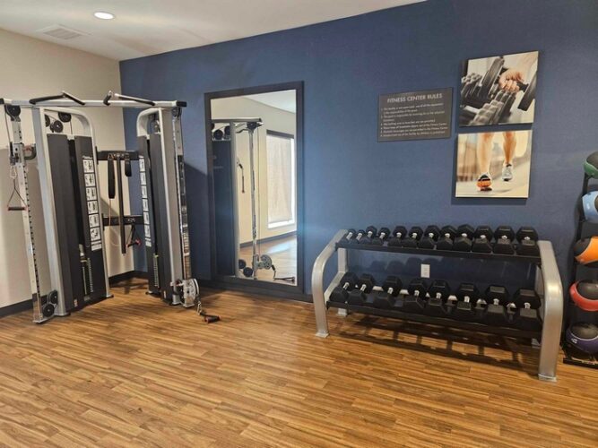 Fitness room with free weights at Comfort Suites