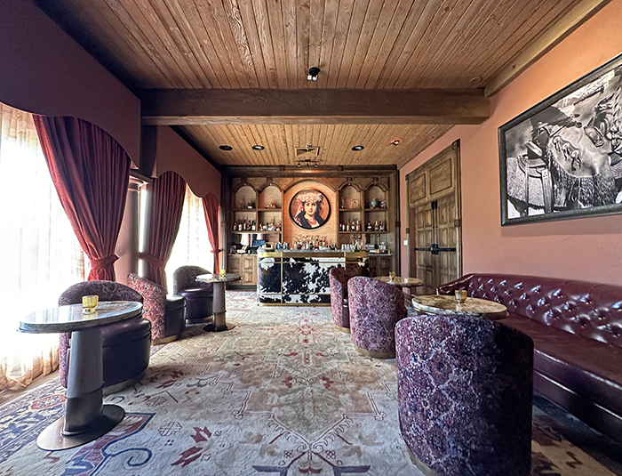 Rustic wood paneling, burgundy leather furnishings and a cow-printed bar are features of The Scottsdale Resort's secret speakeasy