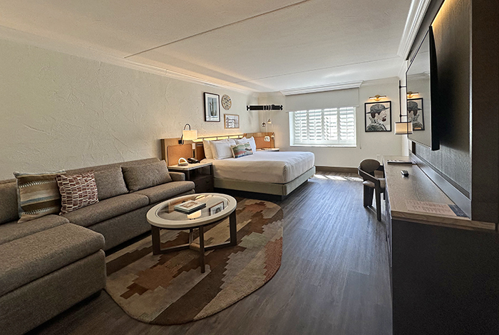 Warm southwest colors and patterns decorate a guest suite with a large bed and sectional sofa