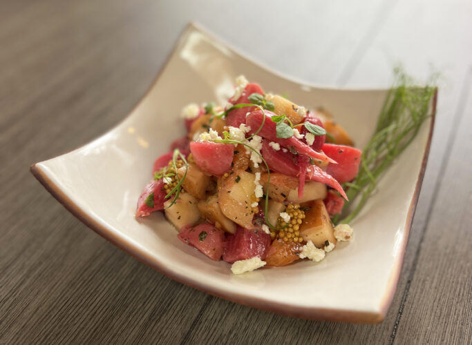 Fresh diced produce in a white square dish with cheese crumbles