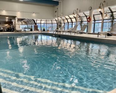 Indoor adult pool, gym, and outdoor patio.