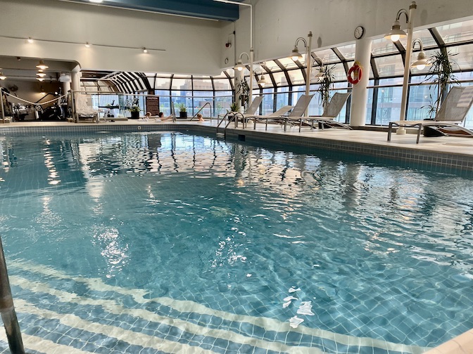 Indoor adult pool, gym, and outdoor patio.