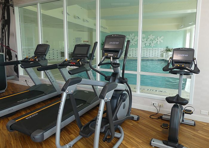 hotel gym facing an indoor pool