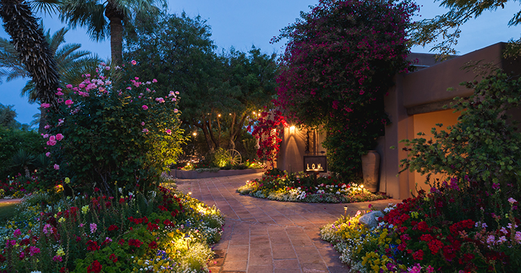 An exterior of Lon's restaurant with sidewalks edged in blooming flowers