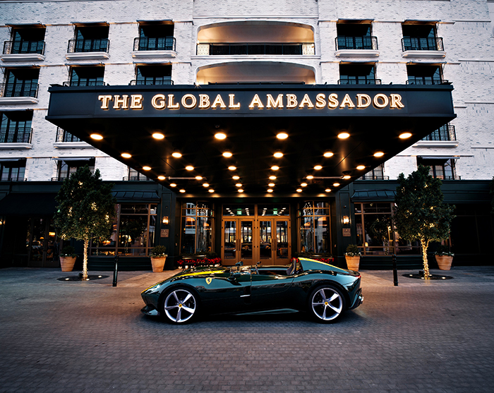 British racing green ferrari sits in front of Global Ambassador porte cochere