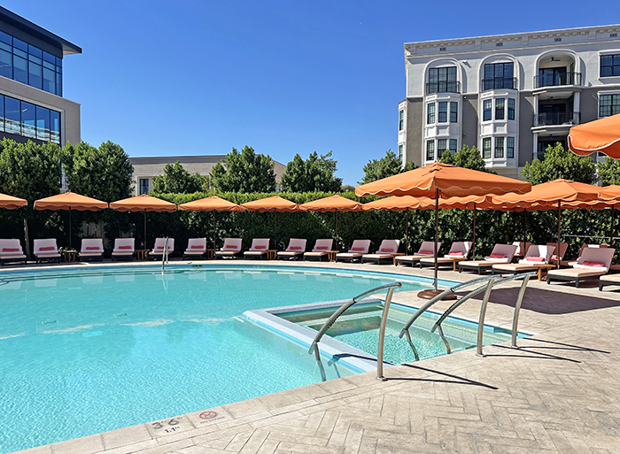 Relaxing lounge seating surrounds the small hotel pool