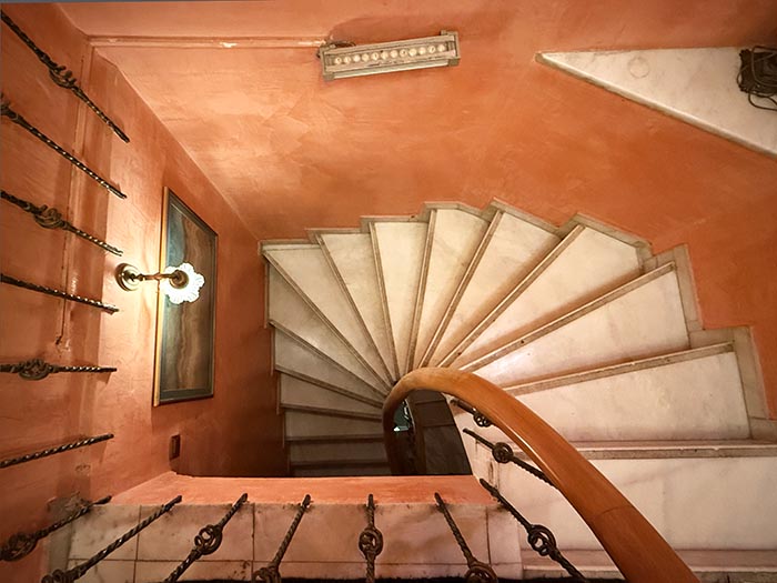 View of narrow spiral staircase looking down from top floor